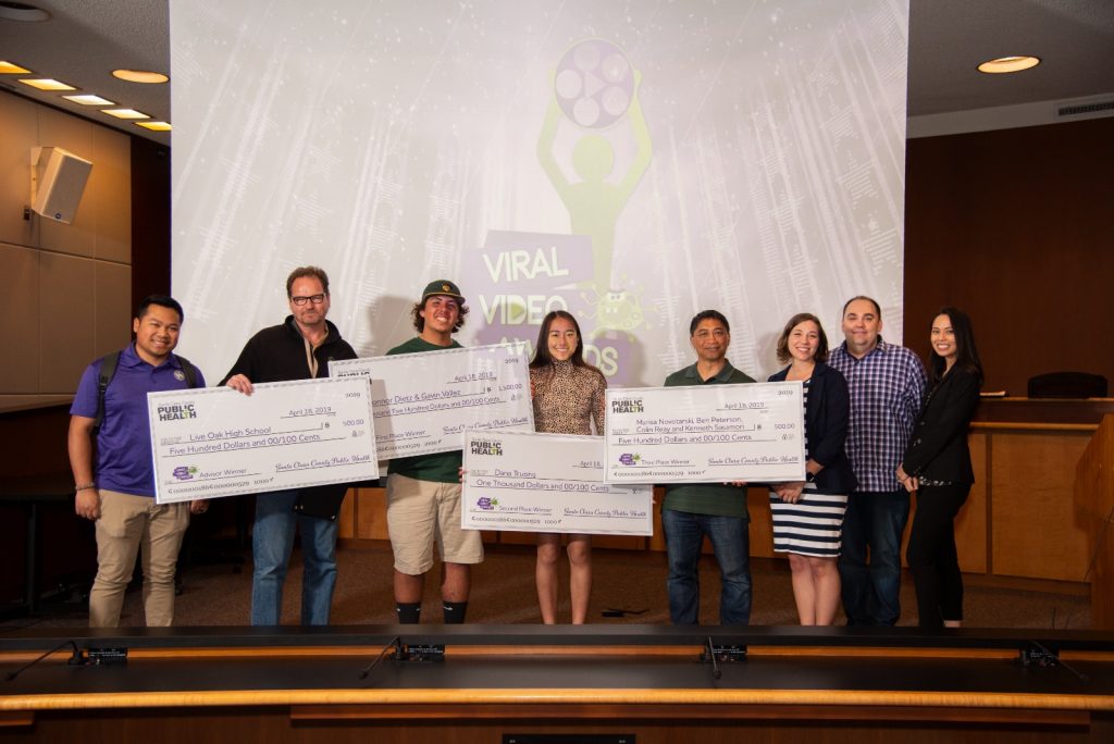 2019 Viral Video Contest Awardees Holding up Checks